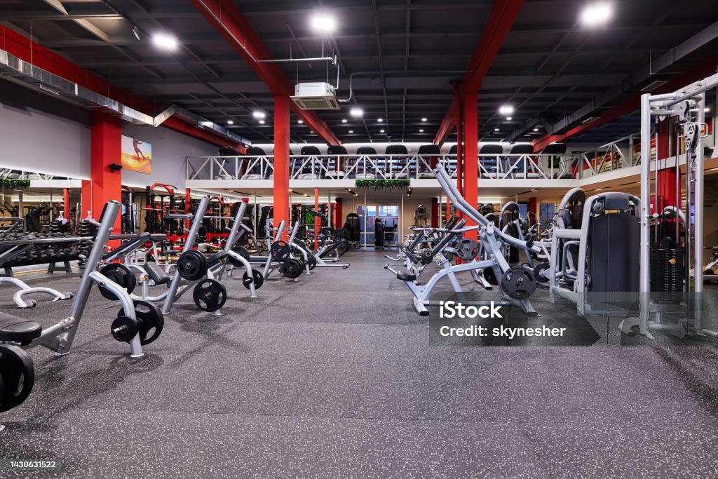 Gym without people with large group of exercise machines. Large group of exercise machines and equipment in a gym. Gym Stock Photo