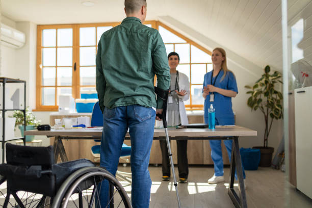 istock Disabled man with crutches in a doctor's office 1430639220