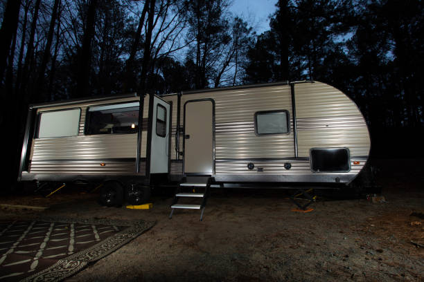 istock Night travel trailer in a forest 1430640364