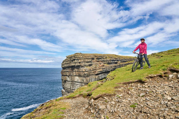 senior woman riding her mountain bike in Ireland stock photo