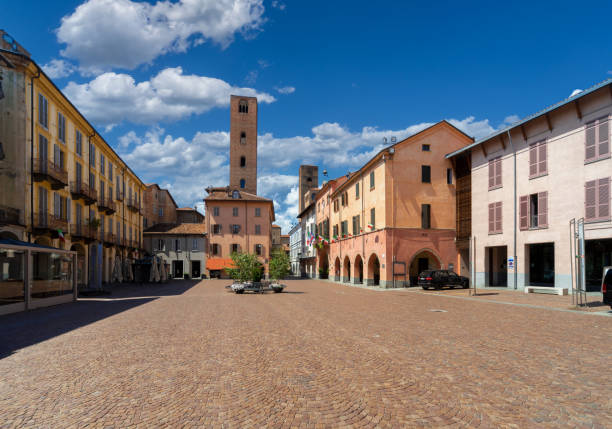 Piazza Risorgimento in Alba, Italy Alba, Langhe, Piedmont, Italy - August 16, 2022: Piazza Risorgimento historic center of the city with the town hall, the arcades and the medieval towers of the age of the communes cuneo stock pictures, royalty-free photos & images