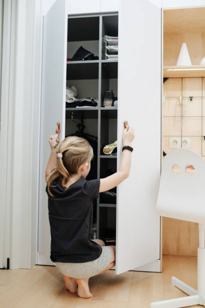 istock Boy is looking in an open closet, choosing clothes 1430650566