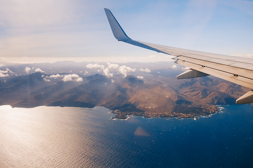 Airplane wing flying above Canary Islands
