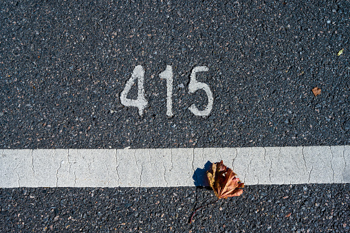 Asphalt with number 415 in white paint