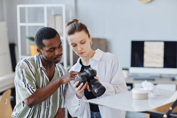 istock Two Photographers Choosing Images In Camera 1430662476