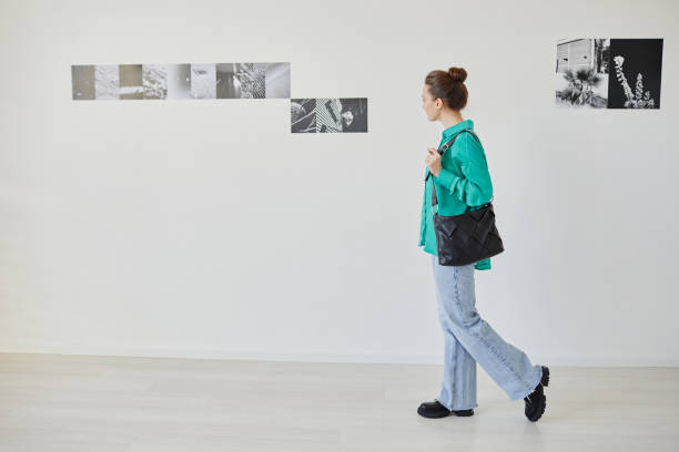 istock Young Woman Visiting Art Gallery Minimal 1430662508