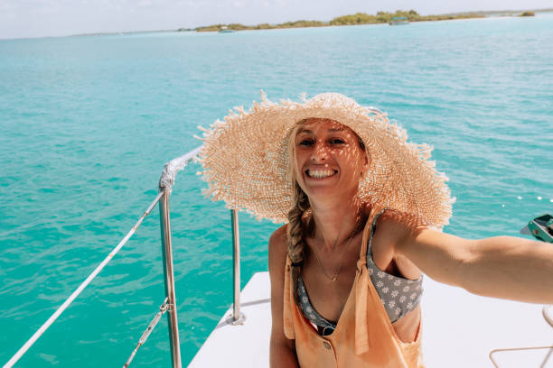 istock Young woman on a catamaran trip takes a selfie 1430663129