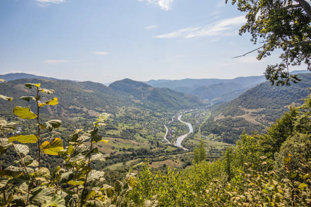 istock View from a high mountain to a valley between mountains with a river and a village on a summer day. View over the hills, mountains, valley, river and village. Carpathians. Ukraine 1430664880
