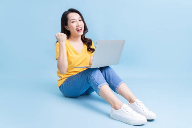 istock Image of young Asian woman sitting and using laptop 1430670034