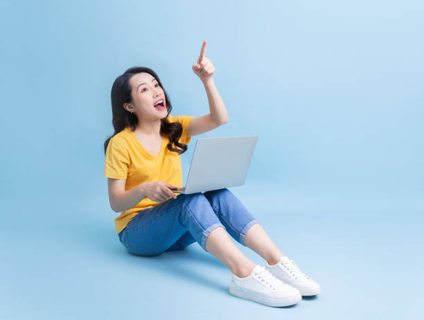 istock Image of young Asian woman sitting and using laptop 1430670048