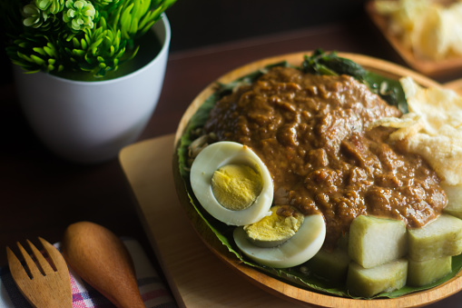 Gado-gado is an authentic Indonesian dish. It is made with mix vegetables, served with rice cake and savory-sweet peanut sauce.