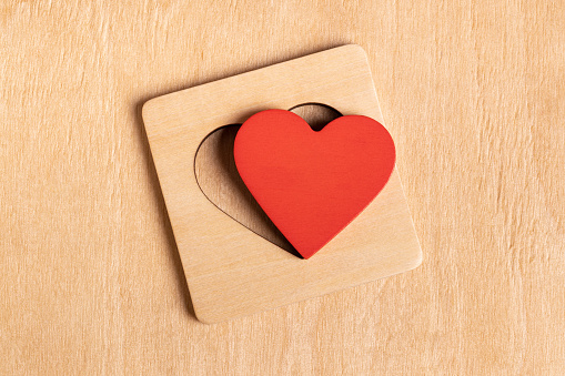 Wooden toy brick with heart cut out. This file is cleaned and retouched.