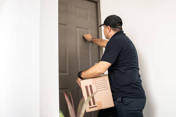 istock Mid adult man delivering package at shipment address 1430673803
