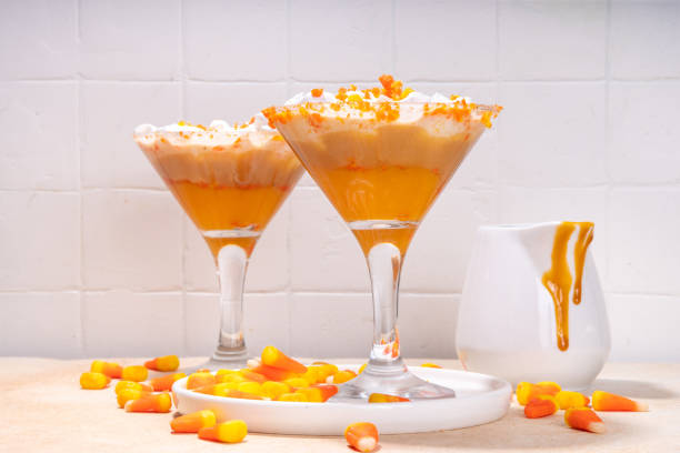 Candy corn martini cocktail Candy corn martini drink. Sweet and salty pumpkin caramel cocktail, with candy corn sweets, copy space ice pie photography stock pictures, royalty-free photos & images