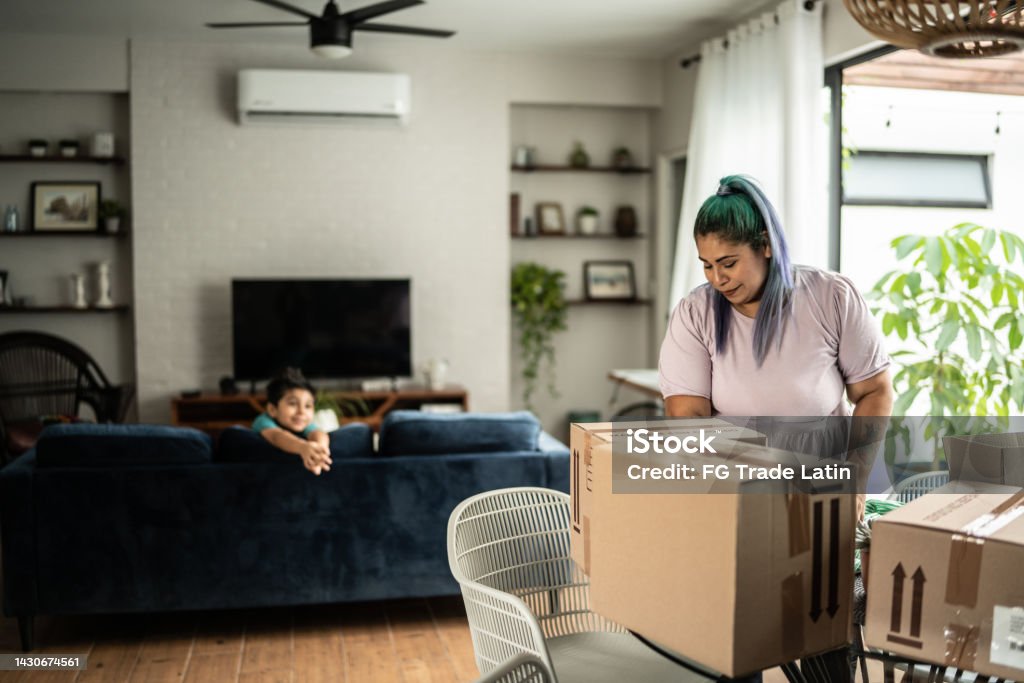 Mid adult woman arranging packages for shipment in the living room at home Business Stock Photo