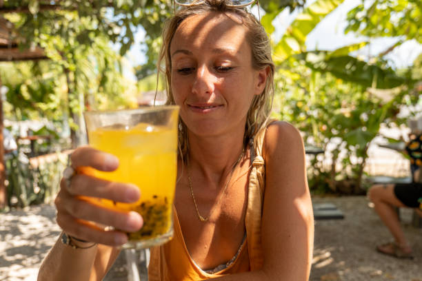 istock Young woman having a fresh passionfruit juice 1430675922