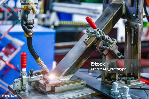 Modern High Quality Automation Welding White Robots Arm At Industrial Stock Photo - Download Image Now