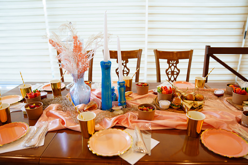 beautiful setting of a table with snacks and dried flowers . original elements of banquet table decoration.