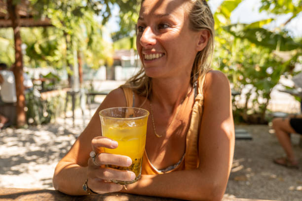istock Young woman having a fresh passionfruit juice 1430676676