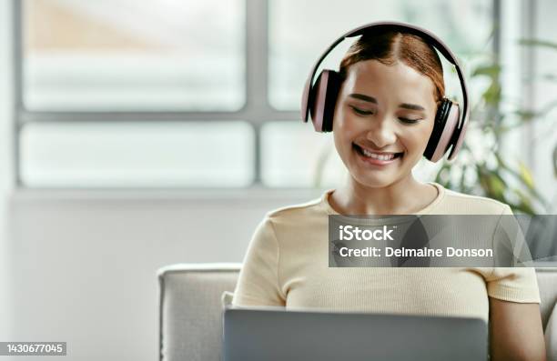 Woman Laptop And Relax In Home While Streaming Movie Podcast Or Video On Internet Girl Happy And Listening To Music Radio Or Song On Computer On App With Headphones In House Or Apartment Stock Photo - Download Image Now