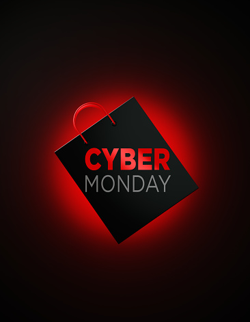Cyber Monday written shopping bag on black background. Cyber Monday writes on the bag. Front view. Horizontal composition with copy space. Great use for Cyber Monday related shopping concepts.
