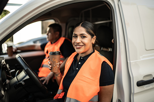Portrait of delivery woman at the driver's seat