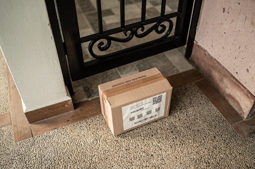 Cardboard box at home entrance door