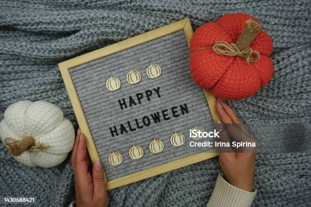 On A Knitted Gray Background A Sign With The Inscription Happy Halloween And There Are Knitted Pumpkins Stock Photo - Download Image Now