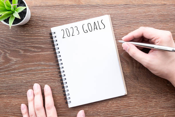 istock Man is writing 2023 goals for new year resolutions plan. 1430689540