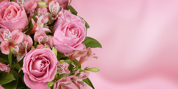 Beautiful pink rose and alstroemeria flowers in a bouquet on soft background