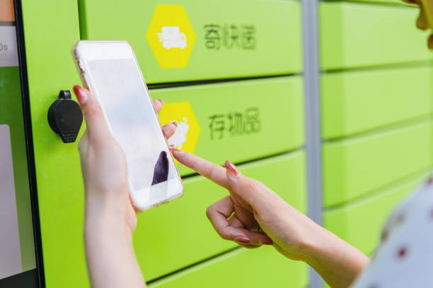istock A woman scans the code on her mobile phone to pick up the courier at the express locker 1430694269