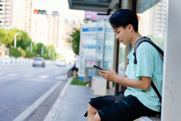 istock A man passes the time at a bus stop waiting for the bus to arrive 1430695105