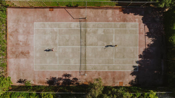 istock Female friends playing tennis 1430699876