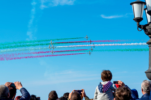 Bari, Italy - May 9, 2019: public crowded on the seafront assists to the evolutions of the aerobatic team of the frecce tricolori during the celebrations for the patron St.Nicholas