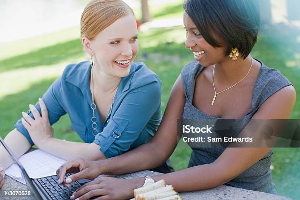 Mujeres De Negocio Trabajando En Una Computadora Portátil En El Parque Foto de stock y más banco de imágenes de 25-29 años