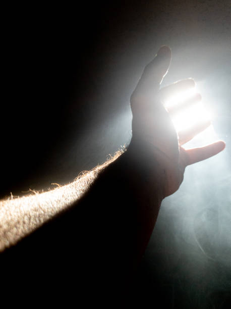 istock left human hand open on the way to skylight light. 1430707516