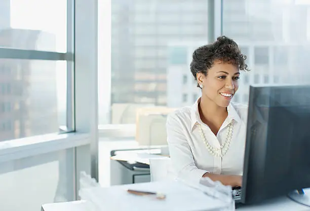 Photo of Businesswoman working at desk in office