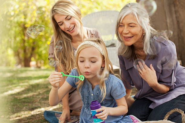 三世代の女性が吹く泡 - bubble wand child blowing asian ethnicity ストックフォトと画像