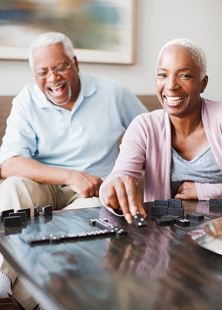 Laughing older couple playing dominoes  domino photos stock pictures, royalty-free photos & images