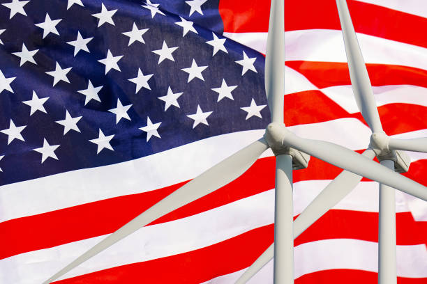 istock Two Wind Turbines for alternative energy on US flag background. Wind turbines generating electricity 1430710920