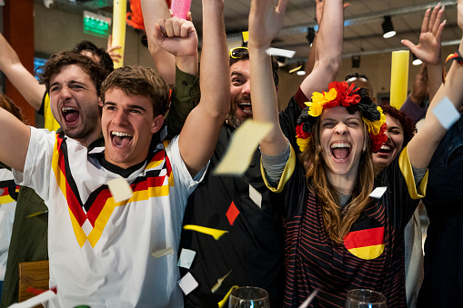 Friends watching and celebrating a sport match