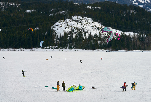 Snow kiters on a windy day on frozen Green Lake in Whistler, BC, Canada. March 2, 2019.