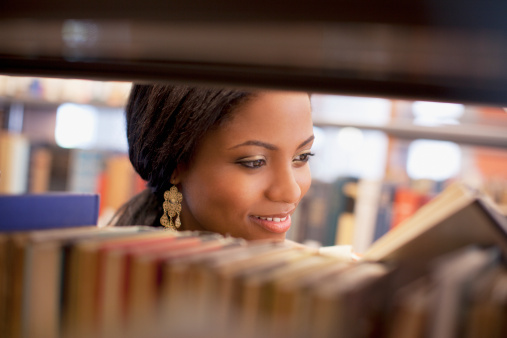 Stack of books opened on library desk