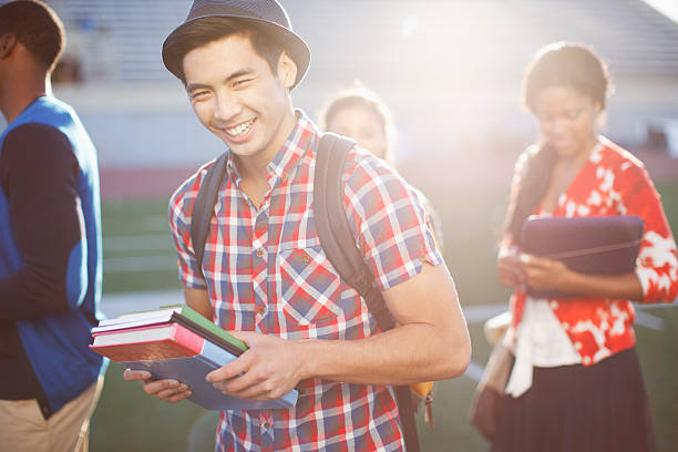 Student carrying books outdoors  school bleachers stock pictures, royalty-free photos & images