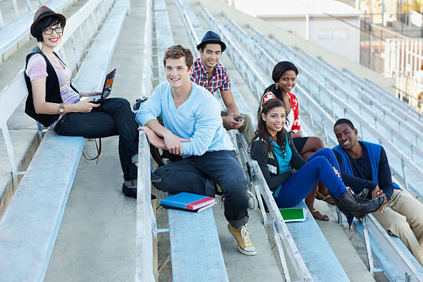 Students sitting on bleachers together  school bleachers stock pictures, royalty-free photos & images