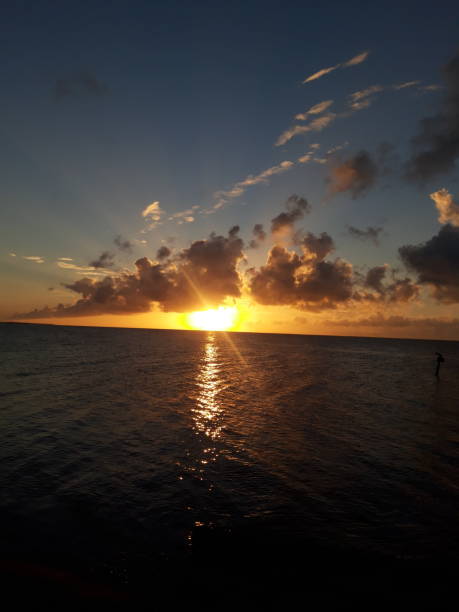 istock Sunrise cloudy beach rocky with sun raise vertical 1430715704