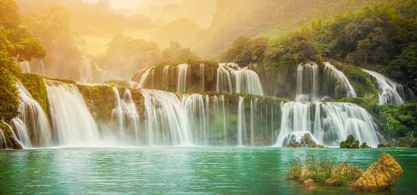 Sunny view of Ban Gioc - Detian waterfall in Cao Bang, Viet Nam. The main of Ban Gioc is divided by two parts for Vietnam and China. It is the most magnificent waterfall in Vietnam.