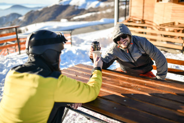 istock Two Males Enjoying Warm Tea After Skiing On Mountain 1430716807
