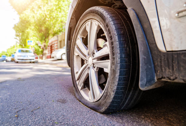 istock a flat car wheel. tire service. pump for car wheels. solar glare 1430719112