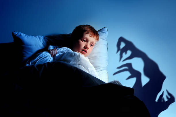 istock Little red haired  boy imagining monsters under the bed 1430722348